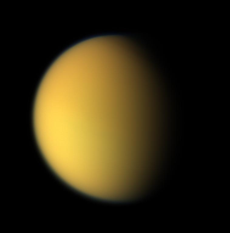 Saturn's moon Titan as a hazy orange globe in natural color from NASA's Cassini spacecraft