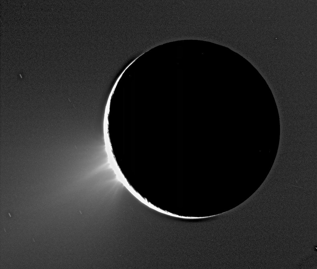 Saturn's moon Enceladus with its icy plumes backlit by the Sun, jets of water ice rising from the south pole, from Cassini