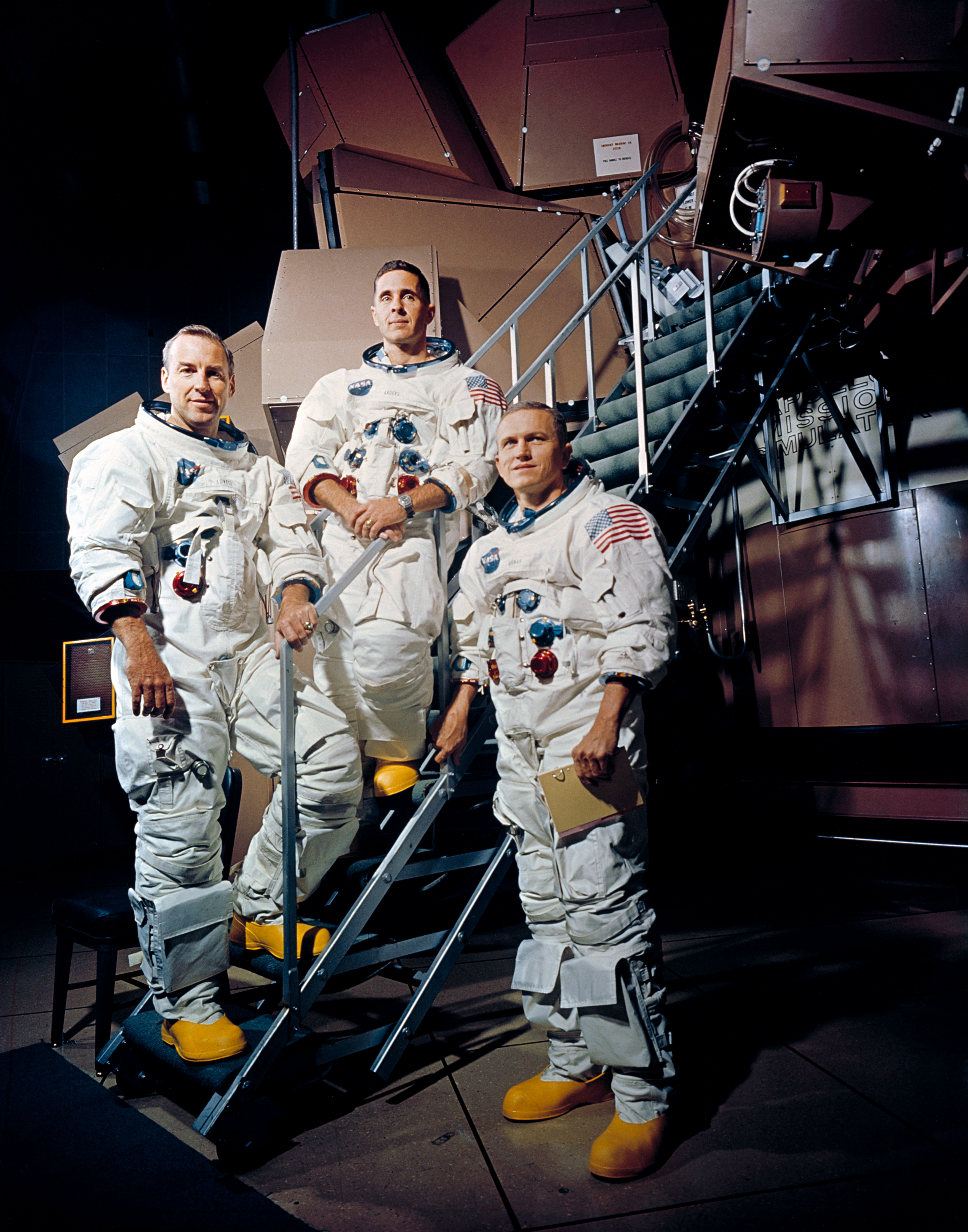 Apollo 8 crew portrait of Frank Borman, James Lovell, and William Anders in their flight suits, 1968.