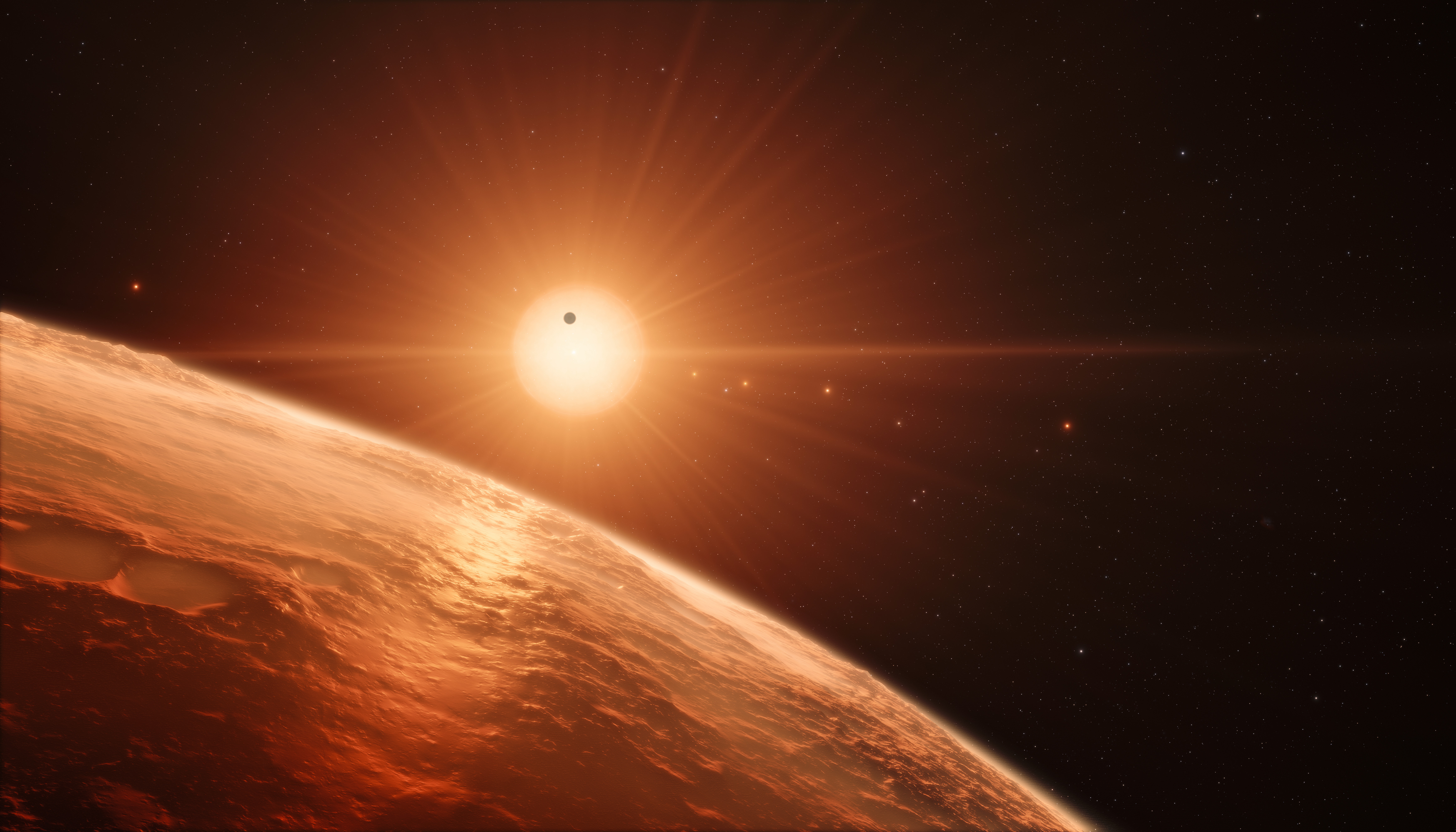 Artist's impression of the TRAPPIST-1 planetary system — seven Earth-sized worlds around a small red star