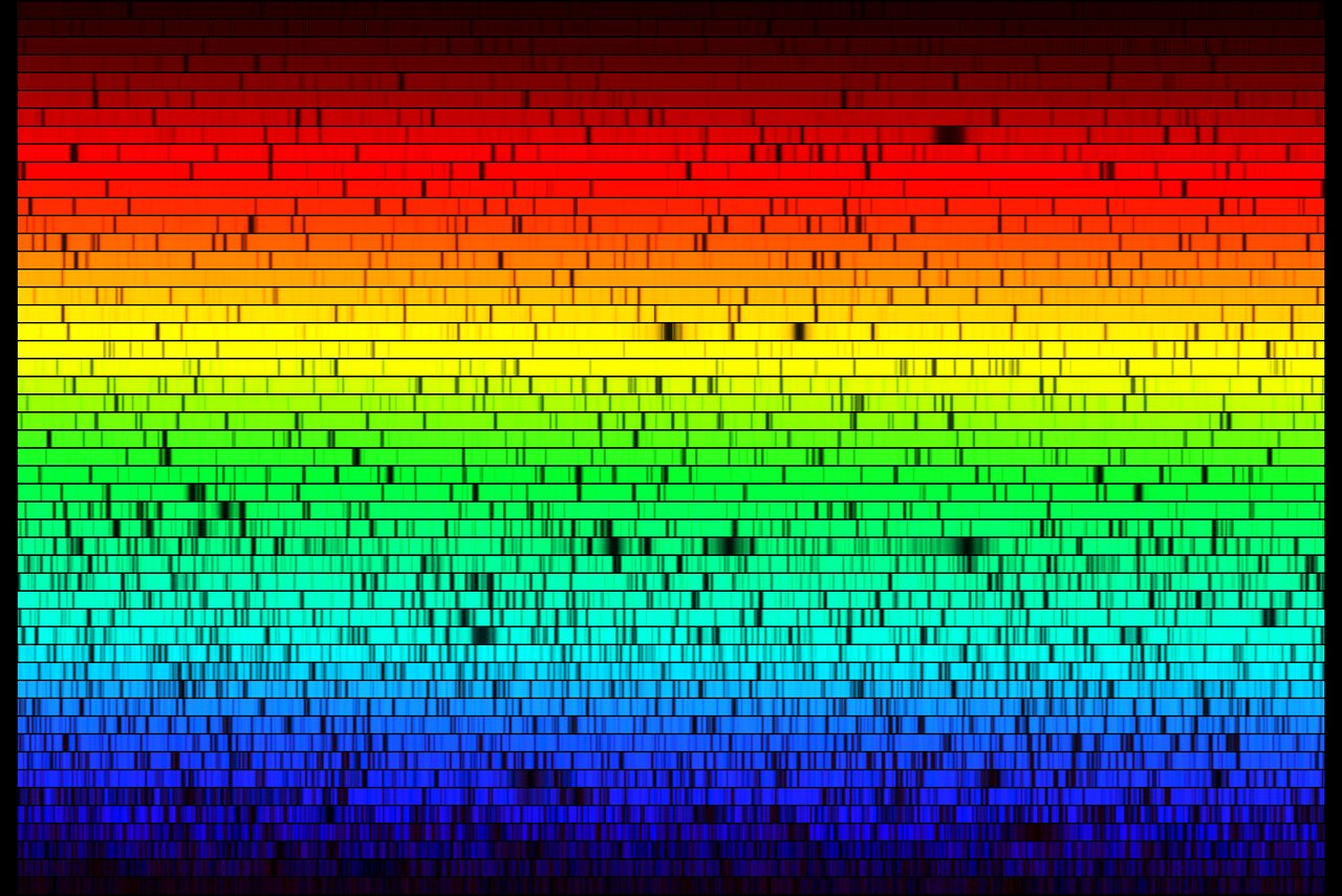 High-resolution spectrum of Arcturus — the star's light spread into 50 stacked rainbow strips crossed by thousands of dark absorption lines, spanning 4000 to 7000 angstroms.