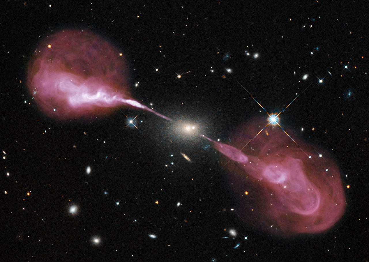 Radio galaxy Hercules A — combined Hubble and Very Large Array image showing a galaxy with enormous twin jets of plasma erupting from its core.