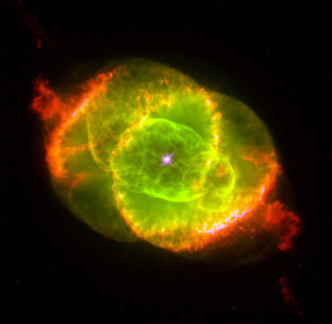 The Cat's Eye Nebula NGC 6543 in Draco — Hubble Space Telescope image showing concentric shells and intricate knots of glowing gas around a dying central star.