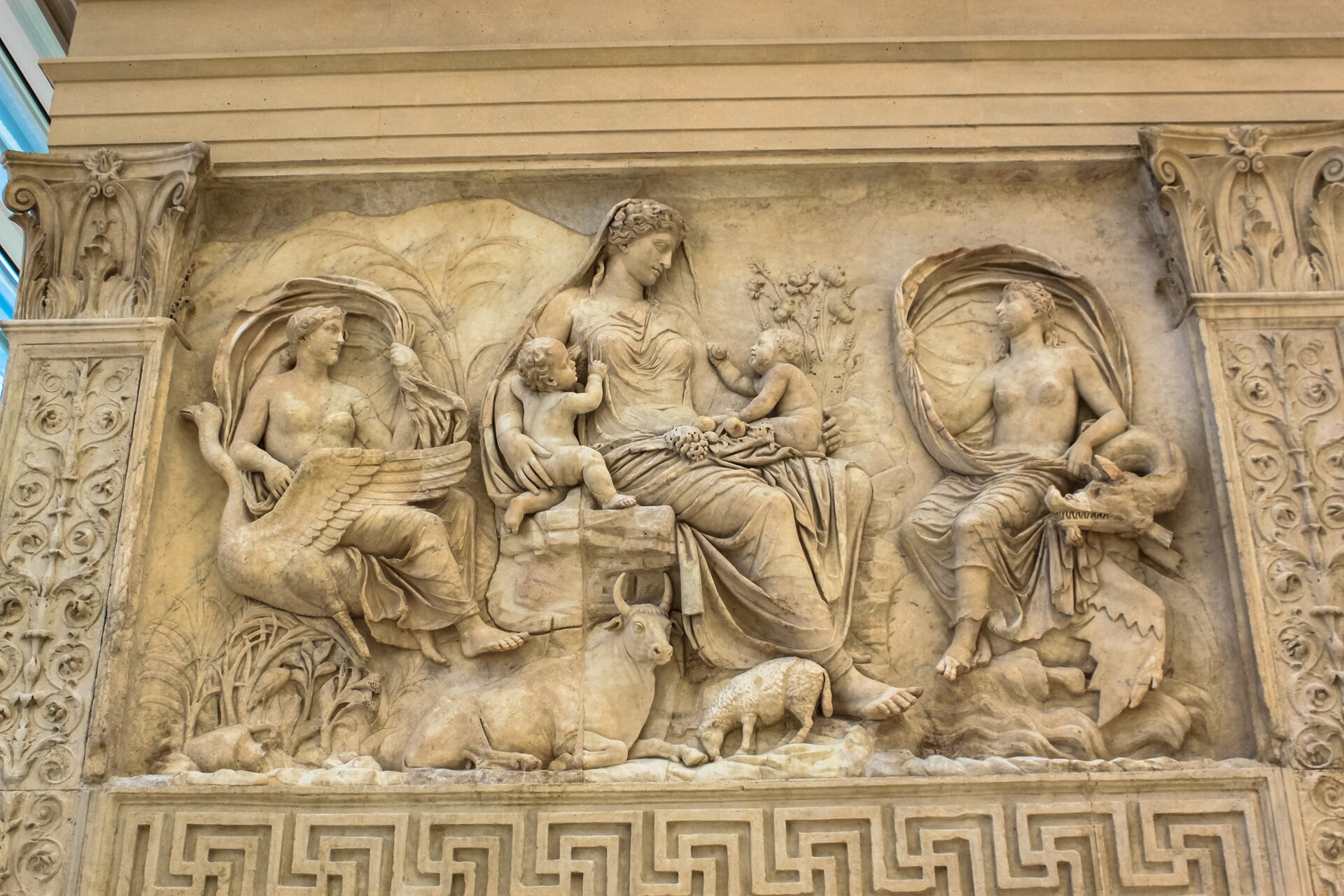 Tellus, Mother Earth, cradling twin infants amid fruit and livestock on the Ara Pacis relief